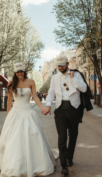 Madrid destination wedding custom caps, couple walking